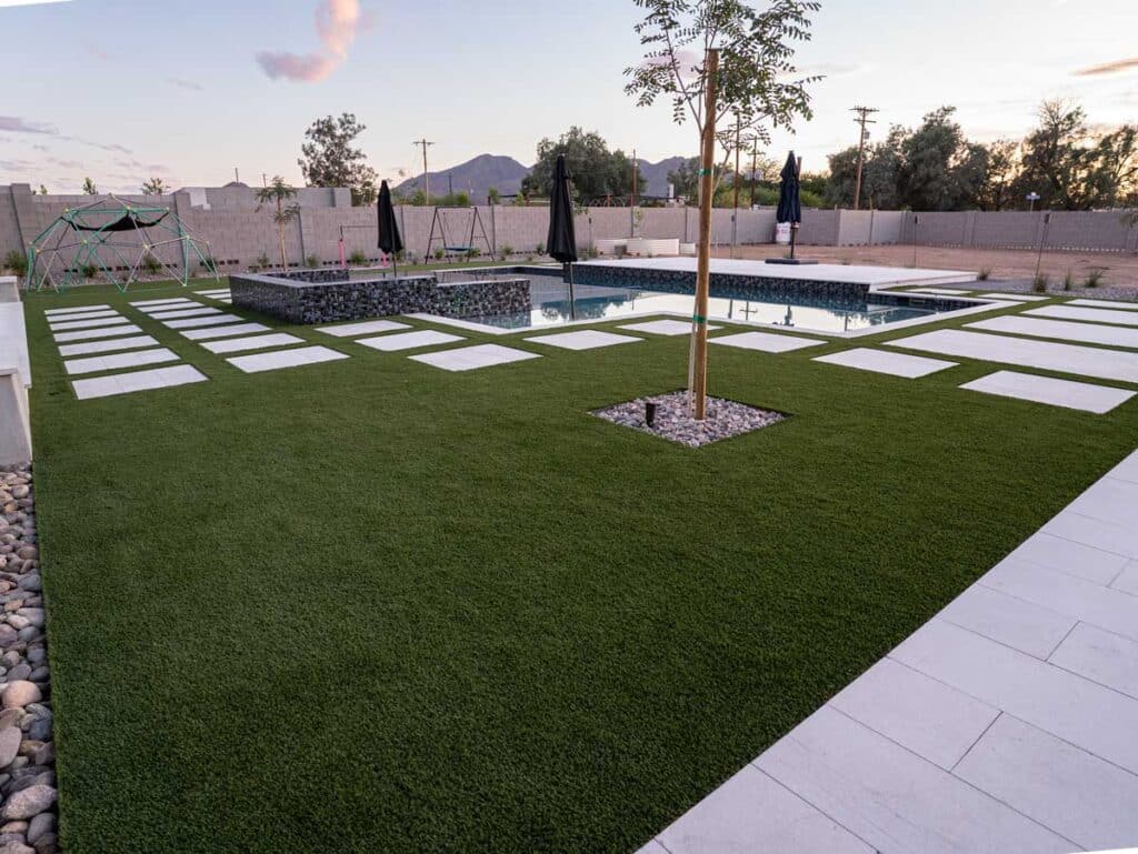 Artificial turf lawn with floating pavers, pool and gabion spa, Queen Creek AZ backyard