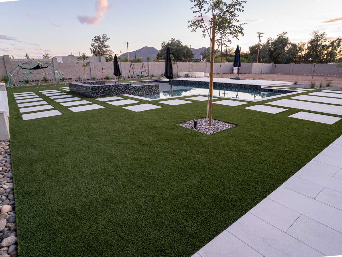Artificial turf lawn with floating pavers, pool and gabion spa, Queen Creek AZ backyard