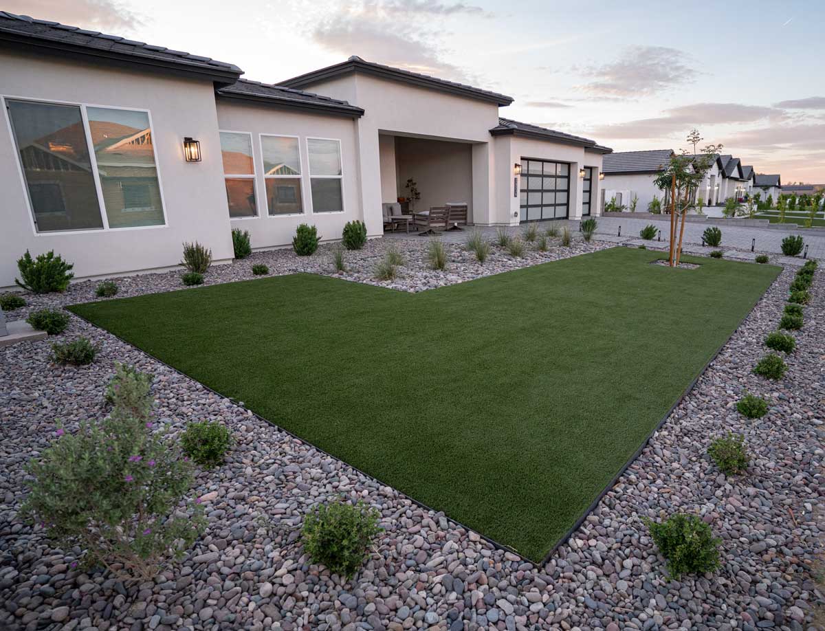 Modern front yard with artificial turf, decorative rock and desert shrubs, Queen Creek