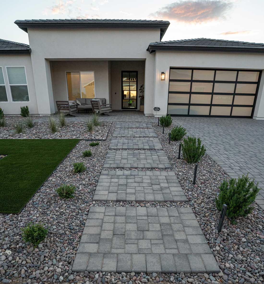 Paver entry walkway with large-format insets through river rock to modern front door, Queen Creek