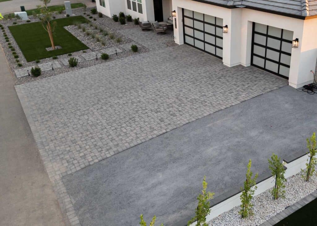 Aerial front yard with paver driveway, artificial turf and river rock landscaping, Queen Creek AZ