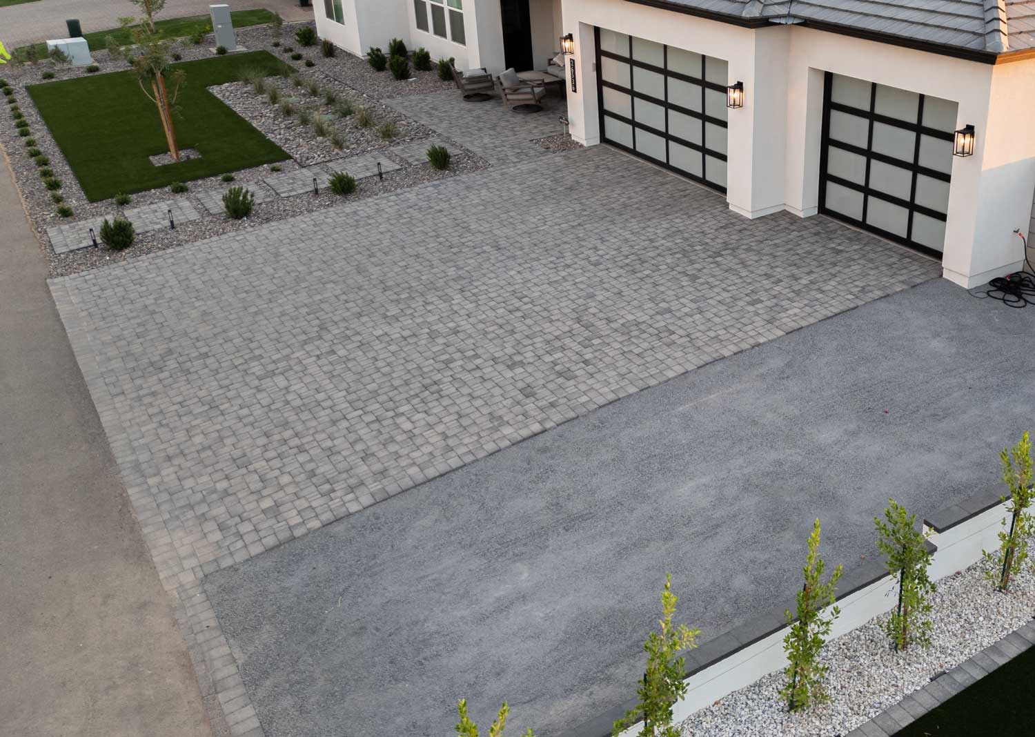 Aerial front yard with paver driveway, artificial turf and river rock landscaping, Queen Creek AZ
